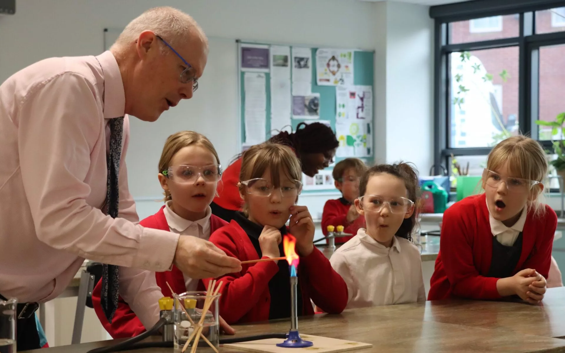 students watching science bunsen burner experiment
